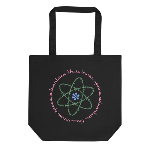 Logo inspired by the attraction with pink stylized retro text reading Adventures Thru Inner Space in a circle, surrounding atomic shaped text in green reading Miracles from Molecules, on a Black tote — flat lay