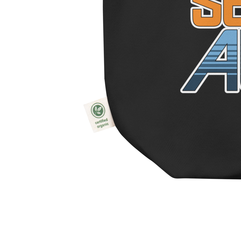 Orange and blue SeaBase Alpha logo with The Living Seas Pavilion icon above, on a Black tote — fabric detail