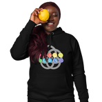 Ten EPCOT pavilion icons in rainbow colors, superimposed on a grey five-ring EPCOT park logo, on a Black hoodie — worn stylishly by a model