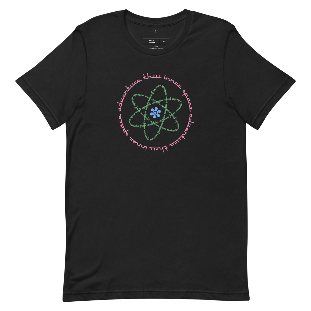 Logo inspired by the attraction with pink stylized retro text reading Adventures Thru Inner Space in a circle, surrounding atomic shaped text in green reading Miracles from Molecules, on a Vintage Black tee — flat lay