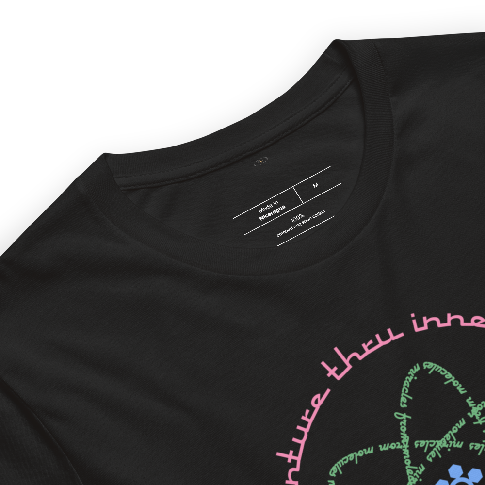 Logo inspired by the attraction with pink stylized retro text reading Adventures Thru Inner Space in a circle, surrounding atomic shaped text in green reading Miracles from Molecules, on a Vintage Black tee — fabric detail