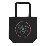 Logo inspired by the attraction with pink stylized retro text reading Adventures Thru Inner Space in a circle, surrounding atomic shaped text in green reading Miracles from Molecules, on a Black tote — flat lay
