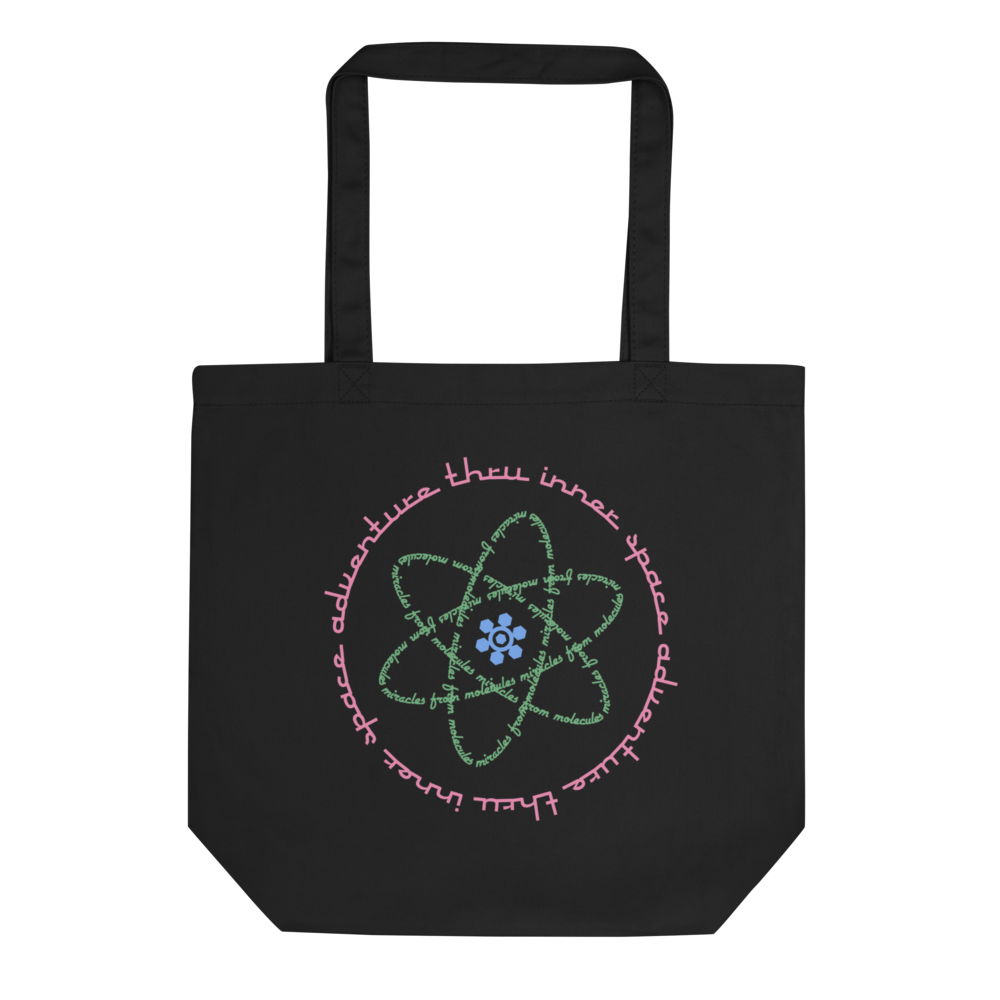 Logo inspired by the attraction with pink stylized retro text reading Adventures Thru Inner Space in a circle, surrounding atomic shaped text in green reading Miracles from Molecules, on a Black tote — flat lay