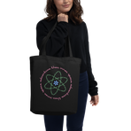 Logo inspired by the attraction with pink stylized retro text reading Adventures Thru Inner Space in a circle, surrounding atomic shaped text in green reading Miracles from Molecules, on a Black tote — worn stylishly by a model
