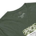 Imagined FASTPASS designed for the unbuilt Museum of the Weird attraction, with green-toned attraction logo, on a tee — fabric detail